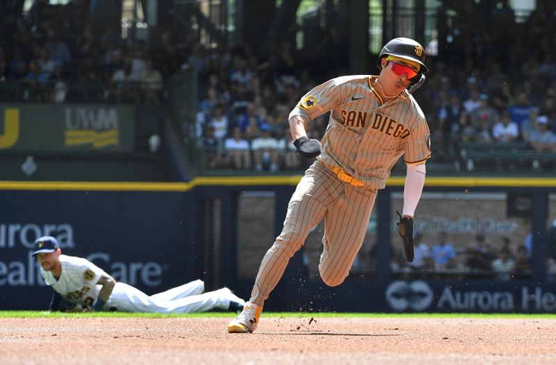 Aug 27, 2023; Milwaukee, Wisconsin, USA; San Diego Padres second baseman Ha-Seong Kim (7) runs from first to third base against the Milwaukee Brewers in the first inning at American Family Field. Mandatory Credit: Michael McLoone-USA TODAY Sports