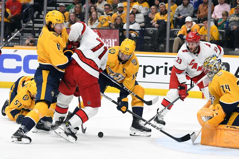 Dec 27, 2023; Nashville, Tennessee, USA; Nashville Predators center Cody Glass (8) hits Carolina Hurricanes right wing Jesper Fast (71) while battling for a puck during the second period at Bridgestone Arena. Mandatory Credit: Christopher Hanewinckel-USA TODAY Sports