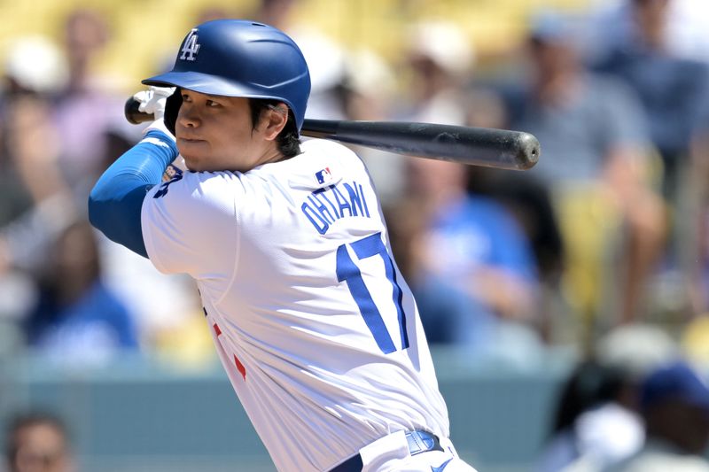 Apr 17, 2024; Los Angeles, California, USA; Los Angeles Dodgers designated hitter player Shohei Ohtani (17) singles in the eighth inning against the Washington Nationals at Dodger Stadium. Mandatory Credit: Jayne Kamin-Oncea-USA TODAY Sports