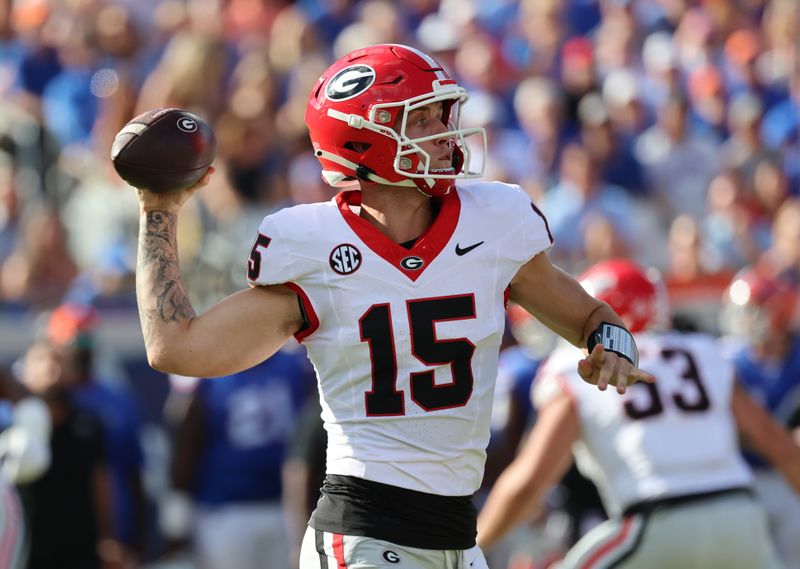 Oct 28, 2023; Jacksonville, Florida, USA; Georgia Bulldogs quarterback Carson Beck (15) throws the ball against the Florida Gators during the first quarter at EverBank Stadium. Mandatory Credit: Kim Klement Neitzel-USA TODAY Sports