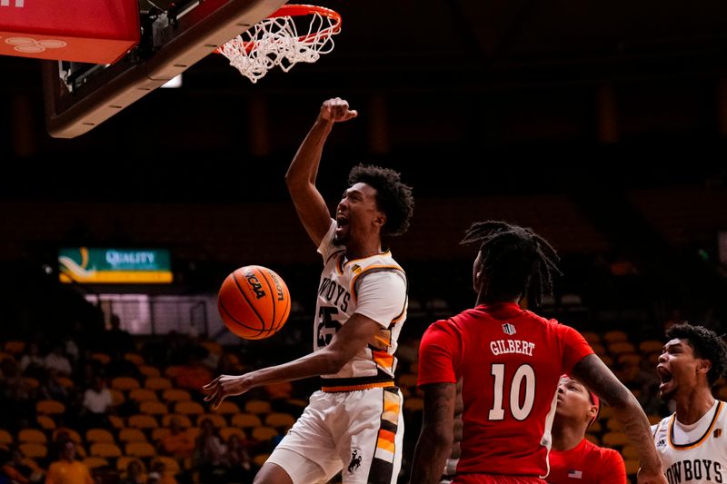 Feb 8, 2023; Laramie, Wyoming, USA; Wyoming Cowboys forward Jeremiah Oden (25) dunks against UNLV Runnin' Rebels guard Keshon Gilbert (10) during the first half at Arena-Auditorium. Mandatory Credit: Troy Babbitt-USA TODAY Sports