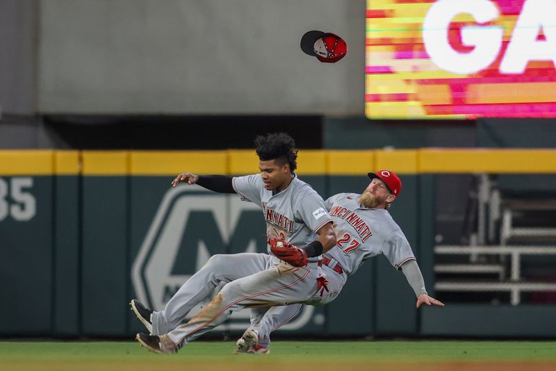 Apr 11, 2023; Atlanta, Georgia, USA; Cincinnati Reds shortstop Jose Barrero (2) collides with left fielder Jake Fraley (27) after a catch against the Atlanta Braves in the seventh inning at Truist Park. Mandatory Credit: Brett Davis-USA TODAY Sports