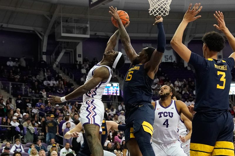 Jan 31, 2023; Fort Worth, Texas, USA; TCU Horned Frogs forward Emanuel Miller (2) scores a layup against West Virginia Mountaineers forward Jimmy Bell Jr. (15) during the first half at Ed and Rae Schollmaier Arena. Mandatory Credit: Chris Jones-USA TODAY Sports