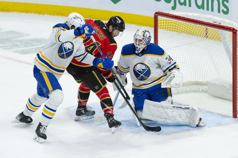 Dec 23, 2025; Ottawa, Ontario, CAN; Buffalo Sabres goalie Alex Lyon (34) makes a save in front of Ottawa Senators center Dylan Cozens (24) in the third period at the Canadian Tire Centre. Mandatory Credit: Marc DesRosiers-IMAGN Images