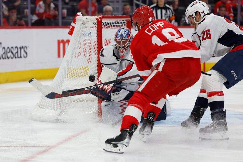 Apr 9, 2024; Detroit, Michigan, USA;  Washington Capitals goaltender Charlie Lindgren (79) makes a save on Detroit Red Wings center Andrew Copp (18) in the second periodat Little Caesars Arena. Mandatory Credit: Rick Osentoski-USA TODAY Sports