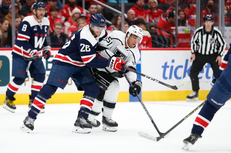 Jan 7, 2024; Washington, District of Columbia, USA; Washington Capitals right wing Nic Dowd (26) battles for the puck with Los Angeles Kings right wing Quinton Byfield (55) during the first period at Capital One Arena. Mandatory Credit: Amber Searls-USA TODAY Sports