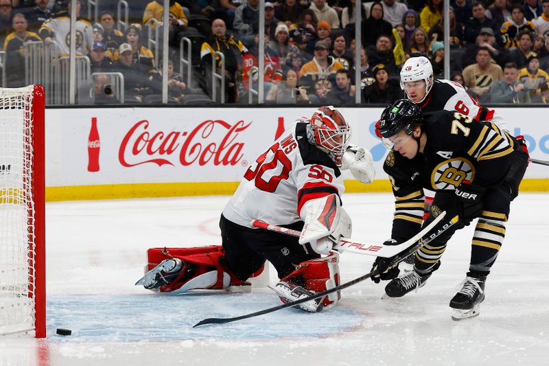 Jan 15, 2024; Boston, Massachusetts, USA; Boston Bruins defenseman Charlie McAvoy (73) hits the post behind New Jersey Devils goaltender Nico Daws (50) during the third period at TD Garden. Mandatory Credit: Winslow Townson-USA TODAY Sports