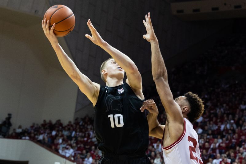 Jan 22, 2023; Bloomington, Indiana, USA; Michigan State Spartans forward Joey Hauser (10) shoots the ball while Indiana Hoosiers forward Trayce Jackson-Davis (23) defends in the second half at Simon Skjodt Assembly Hall. Mandatory Credit: Trevor Ruszkowski-USA TODAY Sports