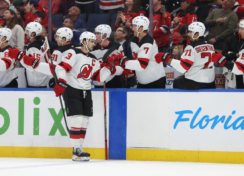 Oct 11, 2025; Tampa, Florida, USA; New Jersey Devils center Nico Hischier (13) is congratulated after he scored a goal against the Tampa Bay Lightning during the first period at Benchmark International Arena. Mandatory Credit: Kim Klement Neitzel-Imagn Images