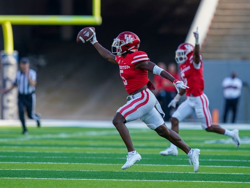 Sep 11, 2021; Houston, Texas, USA;  Houston Cougars safety Hasaan Hypolite (5) celebrates an interception in the first half against the Rice Owls at Rice Stadium. Mandatory Credit: Daniel Dunn-USA TODAY Sports