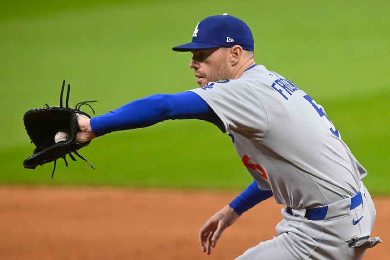 May 27, 2025; Cleveland, Ohio, USA; Los Angeles Dodgers first baseman Freddie Freeman (5) fields a ground ball in the ninth inning against the Cleveland Guardians at Progressive Field. Mandatory Credit: David Richard-Imagn Images