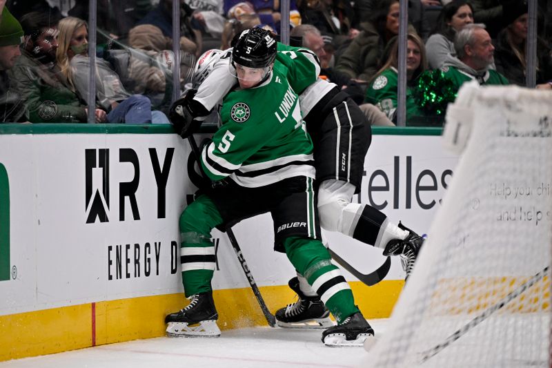 Dec 15, 2025; Dallas, Texas, USA; Dallas Stars defenseman Nils Lundkvist (5) checks Los Angeles Kings right wing Alex Laferriere (14) during the third period at the American Airlines Center. Mandatory Credit: Jerome Miron-Imagn Images
