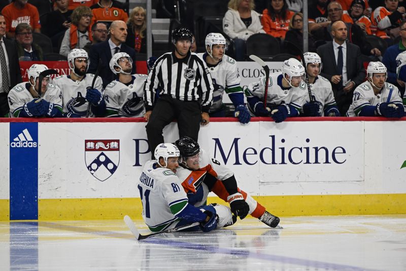 Oct 17, 2023; Philadelphia, Pennsylvania, USA; Vancouver Canucks center Dakota Joshua (81) and Philadelphia Flyers defenseman Travis Sanheim (6) fall to the ice in the third period at the Wells Fargo Center. The Flyers won 2-0. Mandatory Credit: John Geliebter-USA TODAY Sports