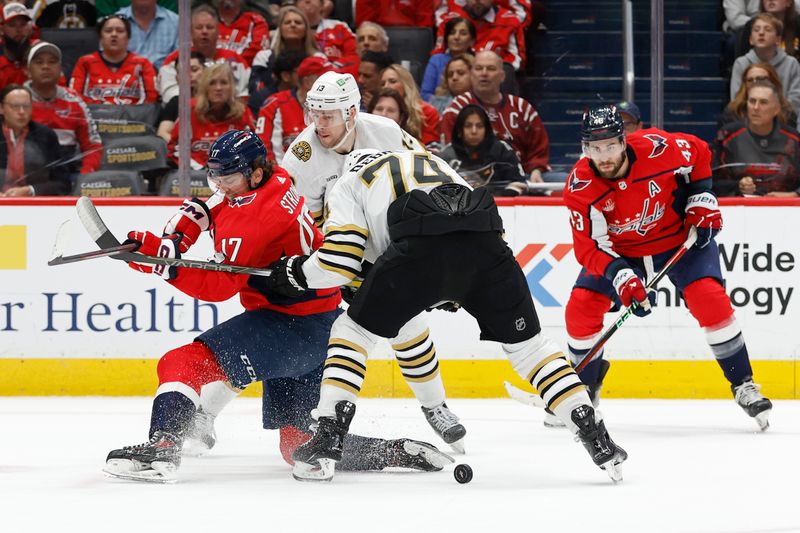 Apr 15, 2024; Washington, District of Columbia, USA; Washington Capitals center Dylan Strome (17) attempts to shoot the puck s Boston Bruins left wing Jake DeBrusk (74) defends in the first period at Capital One Arena. Mandatory Credit: Geoff Burke-USA TODAY Sports