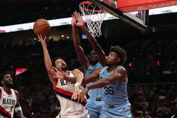 PORTLAND, OREGON - NOVEMBER 05: Skylar Mays #5 of the Portland Trail Blazers drives to the basket as Marcus Smart #36 (R) and Bismack Biyombo #18 (2nd R) of the Memphis Grizzlies defend during the third quarter at Moda Center on November 05, 2023 in Portland, Oregon. NOTE TO USER: User expressly acknowledges and agrees that, by downloading and or using this photograph, User is consenting to the terms and conditions of the Getty Images License Agreement.? (Photo by Amanda Loman/Getty Images)