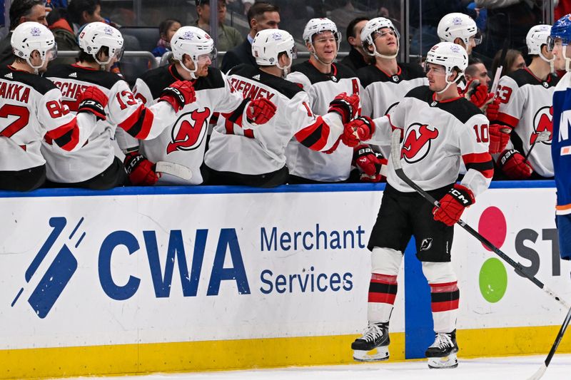 Mar 24, 2024; Elmont, New York, USA;  New Jersey Devils right wing Alexander Holtz (10) celebrates his goal against the New York Islanders during the second period at UBS Arena. Mandatory Credit: Dennis Schneidler-USA TODAY Sports