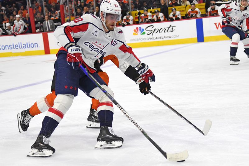 Oct 22, 2024; Philadelphia, Pennsylvania, USA; Washington Capitals left wing Pierre-Luc Dubois (80) carries the puck into the zone against ]Philadelphia Flyers right wing Owen Tippett (74) during the third period at Wells Fargo Center. Mandatory Credit: Eric Hartline-Imagn Images