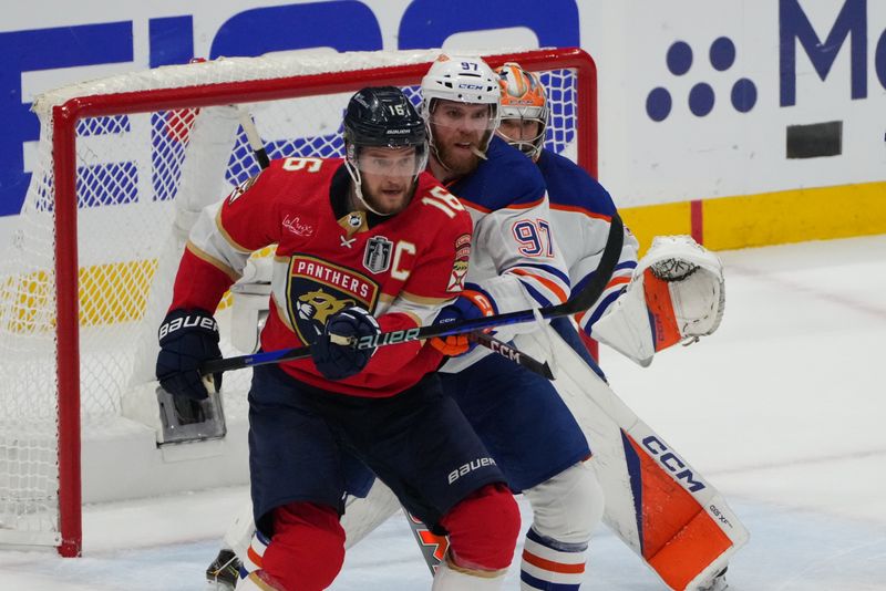 Jun 24, 2024; Sunrise, Florida, USA; Florida Panthers forward Aleksander Barkov (16) defends against Edmonton Oilers forward Connor McDavid (97) during the first period in game seven of the 2024 Stanley Cup Final at Amerant Bank Arena. Mandatory Credit: Jim Rassol-USA TODAY Sports