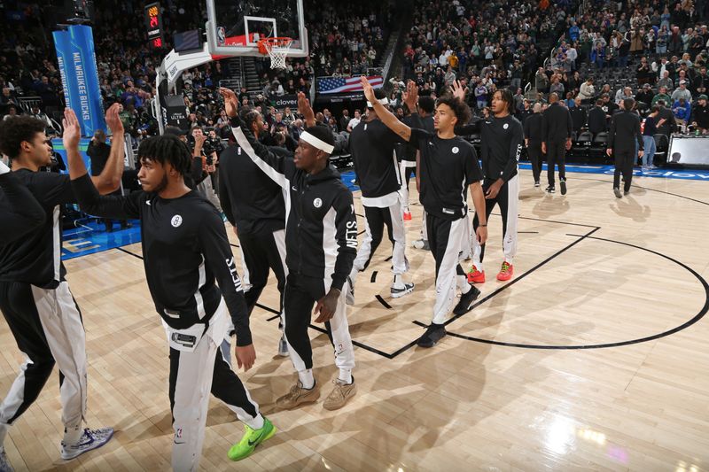 MILWAUKEE, WI - MARCH 21: The Brooklyn Nets high five before the game against the Milwaukee Bucks on March 21, 2024 at the Fiserv Forum Center in Milwaukee, Wisconsin. NOTE TO USER: User expressly acknowledges and agrees that, by downloading and or using this Photograph, user is consenting to the terms and conditions of the Getty Images License Agreement. Mandatory Copyright Notice: Copyright 2024 NBAE (Photo by Gary Dineen/NBAE via Getty Images).