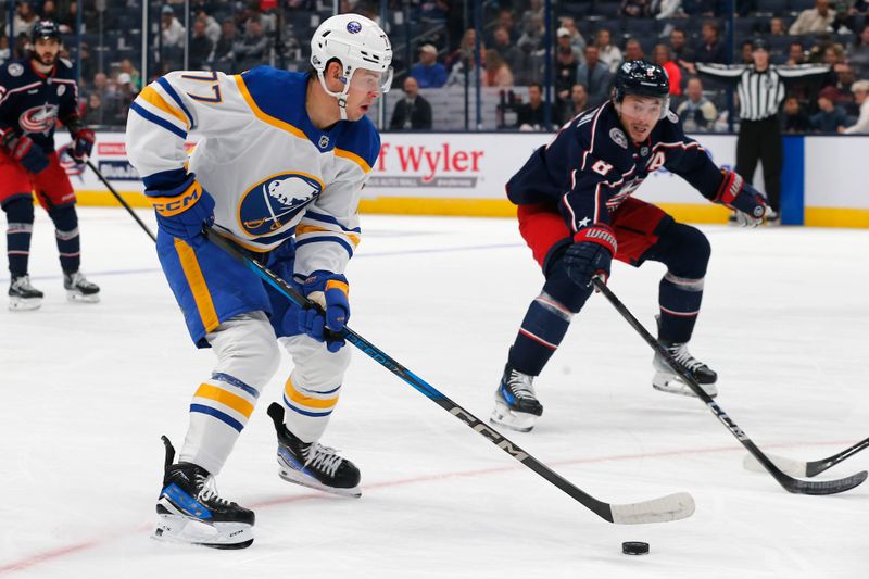 Oct 17, 2024; Columbus, Ohio, USA; Buffalo Sabres right wing John-Jason Peterka (77) carries the puck as Columbus Blue Jackets defenseman Zach Werenski (8) defends during the first period at Nationwide Arena. Mandatory Credit: Russell LaBounty-Imagn Images