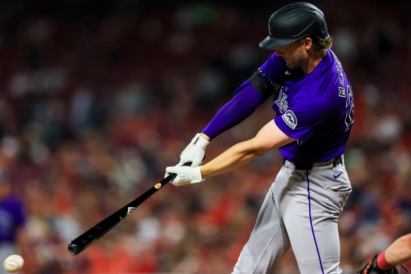 Jul 8, 2024; Cincinnati, Ohio, USA; Colorado Rockies designated hitter Ryan McMahon (24) hits a single against the Cincinnati Reds in the ninth inning at Great American Ball Park. Mandatory Credit: Katie Stratman-USA TODAY Sports