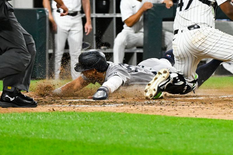 Aug 14, 2024; Chicago, Illinois, USA;  New York Yankees third base Oswaldo Cabrera (95) scores against the Chicago White Sox during the seventh inning at Guaranteed Rate Field. Mandatory Credit: Matt Marton-USA TODAY Sports