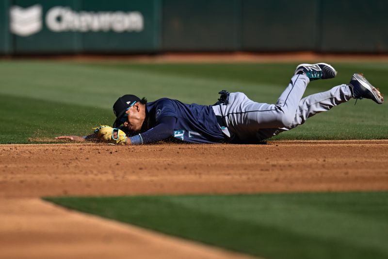 Sep 2, 2024; Oakland, California, USA; Seattle Mariners second base Jorge Polanco (7) catches a ground ball hit by the Oakland Athletics in the second inning at Oakland-Alameda County Coliseum. Mandatory Credit: Eakin Howard-USA TODAY Sports