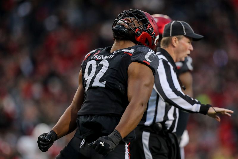 Nov 20, 2021; Cincinnati, Ohio, USA; Cincinnati Bearcats defensive lineman Curtis Brooks (92) reacts after sacking Southern Methodist Mustangs quarterback Tanner Mordecai (not pictured) in the first half at Nippert Stadium. Mandatory Credit: Katie Stratman-USA TODAY Sports