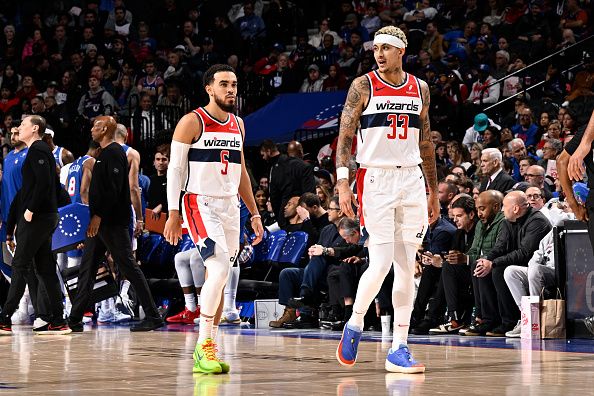 PHILADELPHIA, PA - DECEMBER 11: Tyus Jones #5  and Kyle Kuzma #33 of the Washington Wizards look on during the game against the Philadelphia 76ers on December 11, 2023 at the Wells Fargo Center in Philadelphia, Pennsylvania NOTE TO USER: User expressly acknowledges and agrees that, by downloading and/or using this Photograph, user is consenting to the terms and conditions of the Getty Images License Agreement. Mandatory Copyright Notice: Copyright 2023 NBAE (Photo by David Dow/NBAE via Getty Images)