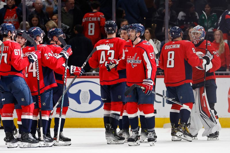 Feb 26, 2024; Washington, District of Columbia, USA; Washington Capitals players celebrate after their game against the Ottawa Senators at Capital One Arena. Mandatory Credit: Geoff Burke-USA TODAY Sports