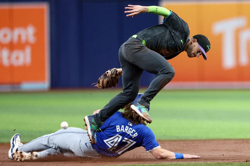 Sep 21, 2024; St. Petersburg, Florida, USA; Tampa Bay Rays second baseman Brandon Lowe (8) attempts to tag Toronto Blue Jays outfielder Addison Barger (47) in the first inning at Tropicana Field. Mandatory Credit: Nathan Ray Seebeck-Imagn Images