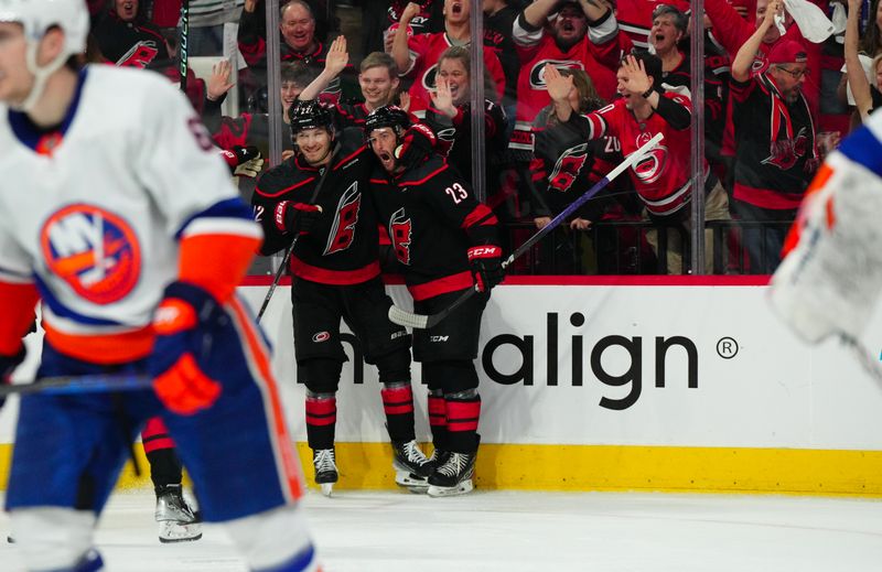 Apr 20, 2024; Raleigh, North Carolina, USA; Carolina Hurricanes right wing Stefan Noesen (23) celebrates his goal with with defenseman Brett Pesce (22) during the third period against the New York Islanders in game one of the first round of the 2024 Stanley Cup Playoffs at PNC Arena. Mandatory Credit: James Guillory-USA TODAY Sports