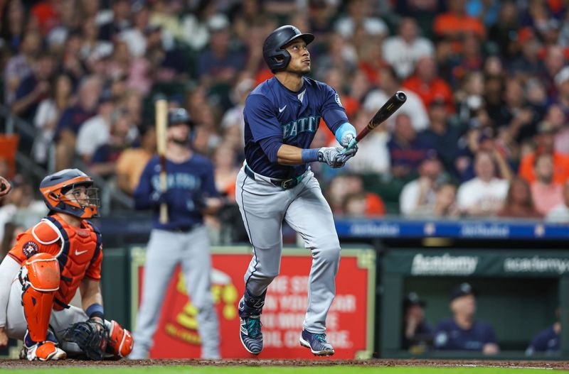 May 3, 2024; Houston, Texas, USA; Seattle Mariners second baseman Jorge Polanco (7) hits a home run during the third inning against the Houston Astros at Minute Maid Park. Mandatory Credit: Troy Taormina-USA TODAY Sports