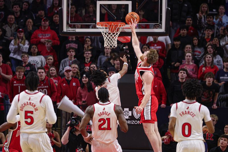 Jan 2, 2026; Piscataway, New Jersey, USA; Ohio State Buckeyes forward Brandon Noel (14) blocks a shot by Rutgers Scarlet Knights guard Jamichael Davis (1) during the first half at Jersey Mike's Arena. Mandatory Credit: Vincent Carchietta-Imagn Images