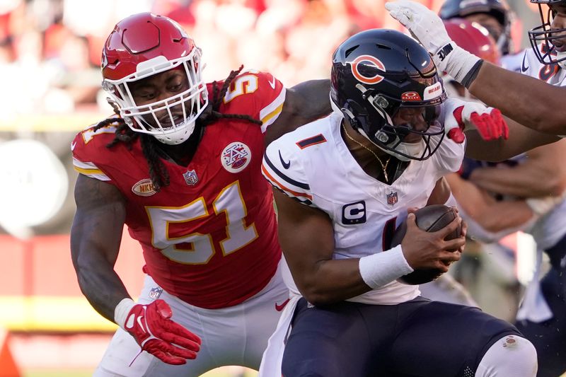 Chicago Bears quarterback Justin Fields (1) is sacked for a 4-yard loss by Kansas City Chiefs defensive end Mike Danna (51) during the second half of an NFL football game Sunday, Sept. 24, 2023, in Kansas City, Mo. (AP Photo/Ed Zurga)