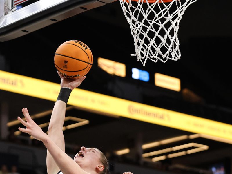 Mar 5, 2023; Minneapolis, MINN, USA; Iowa Hawkeyes forward Monika Czinano (25) shoots while Ohio State Buckeyes forward Cotie McMahon (32) defends during the first half at Target Center. Mandatory Credit: Matt Krohn-USA TODAY Sports