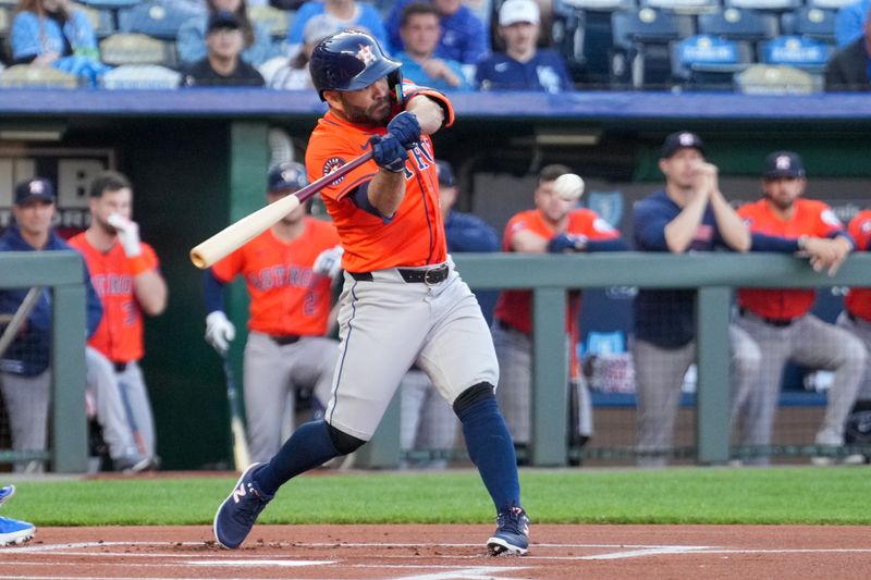 Apr 9, 2024; Kansas City, Missouri, USA; Houston Astros second base Jose Altuve (27) singles against the Kansas City Royals in the first inning at Kauffman Stadium. Mandatory Credit: Denny Medley-USA TODAY Sports