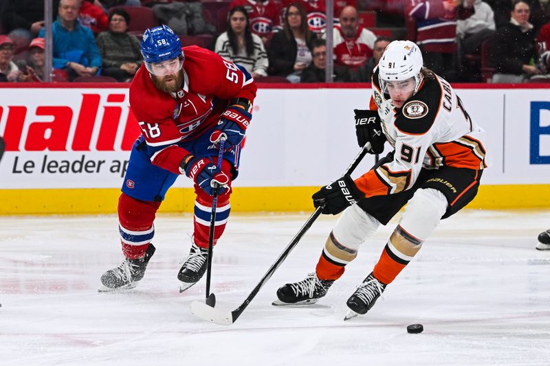 Feb 13, 2024; Montreal, Quebec, CAN; Anaheim Ducks center Leo Carlsson (91) defends against Montreal Canadiens defenseman David Savard (58) during the second period at Bell Centre. Mandatory Credit: David Kirouac-USA TODAY Sports