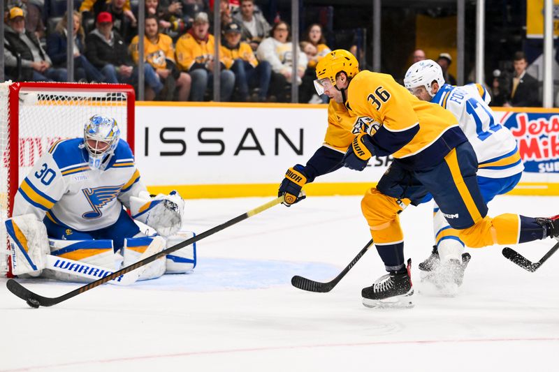 Feb 2, 2026; Nashville, Tennessee, USA;  St. Louis Blues goaltender Joel Hofer (30) blocks the shot of Nashville Predators left wing Cole Smith (36) during the second period at Bridgestone Arena. Mandatory Credit: Steve Roberts-Imagn Images
