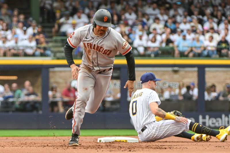 May 27, 2023; Milwaukee, Wisconsin, USA; San Francisco Giants first baseman LaMonte Wade Jr. (31) advances to third base after an error on a pickoff attempt in the first inning during game against the Milwaukee Brewers at American Family Field. Mandatory Credit: Benny Sieu-USA TODAY Sports