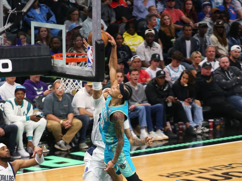 CHARLOTTE, NC - APRIL 9: Daniel Gafford #21 of the Dallas Mavericks blocks the dunk attempt by Tre Mann #23 of the Charlotte Hornets during the game on April 9, 2024 at Spectrum Center in Charlotte, North Carolina. NOTE TO USER: User expressly acknowledges and agrees that, by downloading and or using this photograph, User is consenting to the terms and conditions of the Getty Images License Agreement. Mandatory Copyright Notice: Copyright 2024 NBAE (Photo by Kent Smith/NBAE via Getty Images)