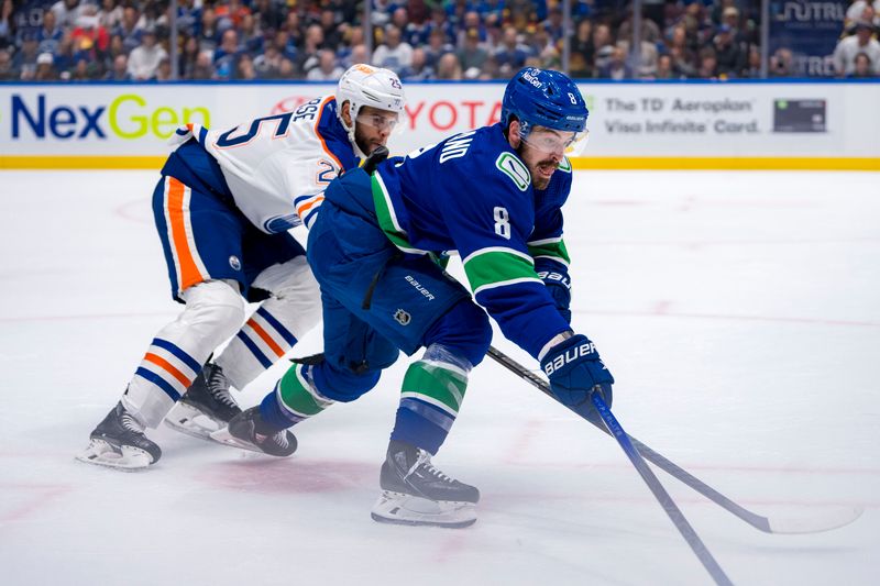 May 8, 2024; Vancouver, British Columbia, CAN; Vancouver Canucks forward Conor Garland (8) drives past Edmonton Oilers defenseman Darnell Nurse (25) on the way to scoring the game winning goal during the third period in game one of the second round of the 2024 Stanley Cup Playoffs at Rogers Arena. Mandatory Credit: Bob Frid-USA TODAY Sports