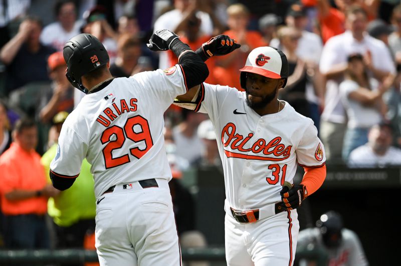 Sep 22, 2024; Baltimore, Maryland, USA;  Baltimore Orioles outfielder Cedric Mullins (31) celebrates with third baseman Ramón Urías (29) after hitting a fifth inning solo home run against the Detroit Tigers at Oriole Park at Camden Yards. Mandatory Credit: Tommy Gilligan-Imagn Images