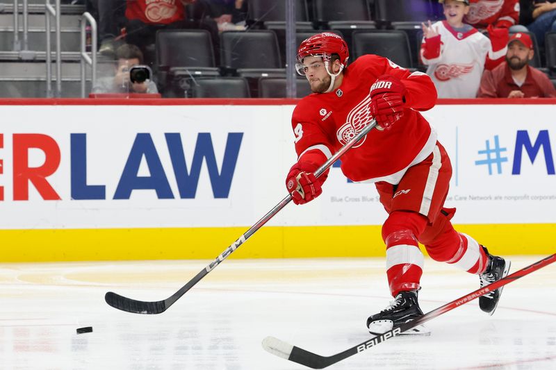 Oct 4, 2024; Detroit, Michigan, USA;  Detroit Red Wings left wing Carter Mazur (43) takes a shot in the second period against the Ottawa Senators at Little Caesars Arena. Mandatory Credit: Rick Osentoski-Imagn Images