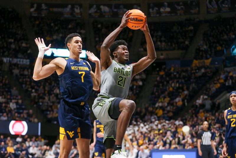 Feb 17, 2024; Morgantown, West Virginia, USA; Baylor Bears center Yves Missi (21) drives past West Virginia Mountaineers center Jesse Edwards (7) during the first half at WVU Coliseum. Mandatory Credit: Ben Queen-USA TODAY Sports