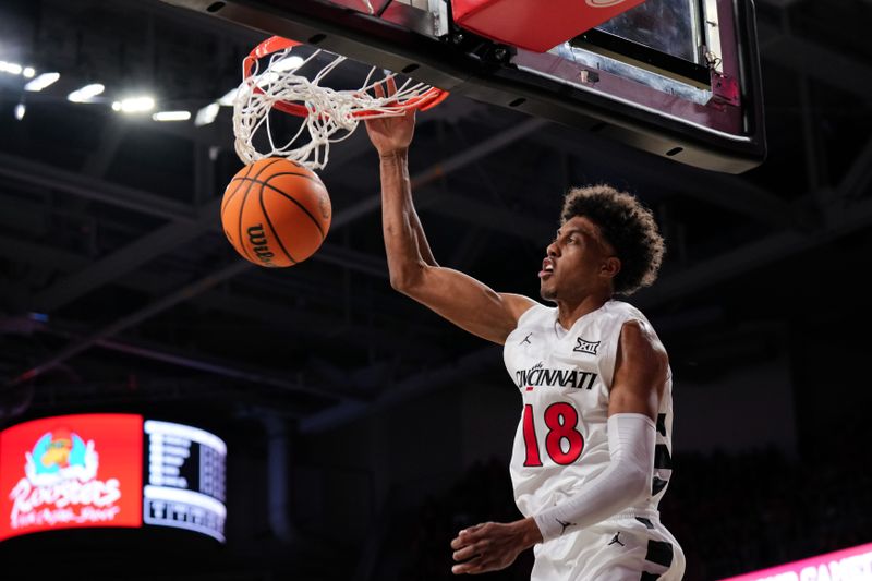 Mar 3, 2026; Cincinnati, Ohio, USA;  Cincinnati Bearcats forward Baba Miller (18) dunks the ball against the BYU Cougars in the first half at Fifth Third Arena. Mandatory Credit: Aaron Doster-Imagn Images