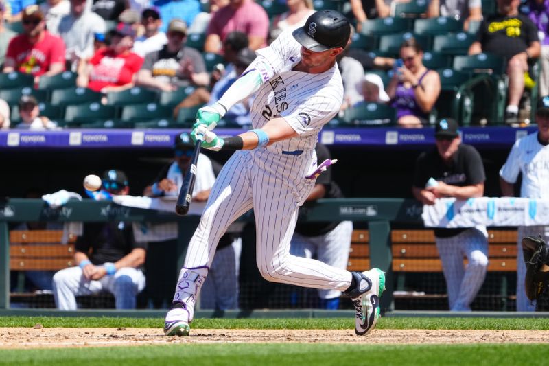 Jun 16, 2024; Denver, Colorado, USA; Colorado Rockies left fielder Nolan Jones (22) singles in the seventh inning against the Pittsburgh Pirates at Coors Field. Mandatory Credit: Ron Chenoy-USA TODAY Sports