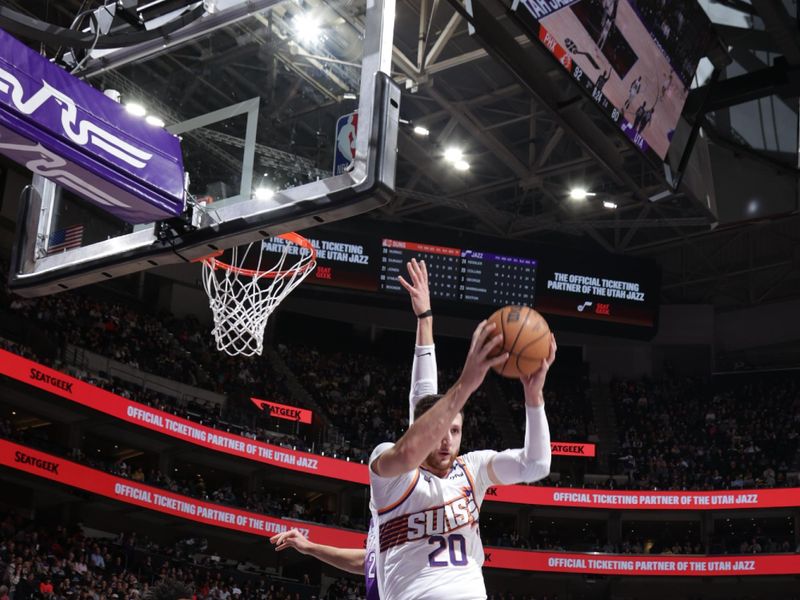 SALT LAKE CITY, UT - DECEMBER 13:  Jusuf Nurkic #20 of the Phoenix Suns grabs the rebound during the game against the Utah Jazz during a regular season game on December 13, 2024 at Delta Center in Salt Lake City, Utah. NOTE TO USER: User expressly acknowledges and agrees that, by downloading and or using this Photograph, User is consenting to the terms and conditions of the Getty Images License Agreement. Mandatory Copyright Notice: Copyright 2024 NBAE (Photo by Melissa Majchrzak/NBAE via Getty Images)