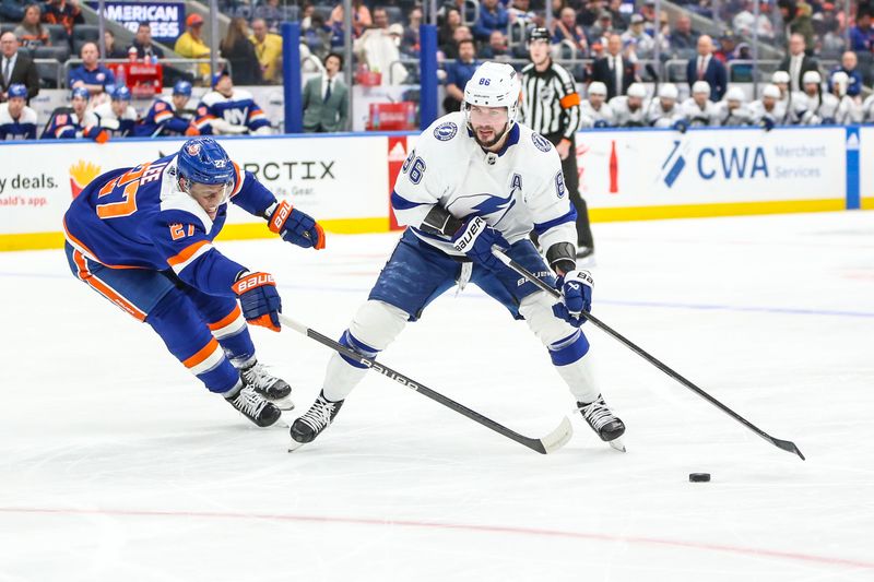 Feb 24, 2024; Elmont, New York, USA;  New York Islanders left wing Anders Lee (27) and Tampa Bay Lightning right wing Nikita Kucherov (86) battle for control of the puck in the first period at UBS Arena. Mandatory Credit: Wendell Cruz-USA TODAY Sports