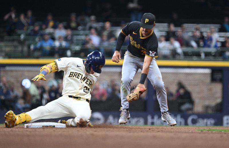 May 14, 2024; Milwaukee, Wisconsin, USA; Milwaukee Brewers outfielder Christian Yelich (22) slides in safely ahead of the tag by Pittsburgh Pirates second base Nick Gonzales (39) in the seventh inning at American Family Field. Mandatory Credit: Michael McLoone-USA TODAY Sports